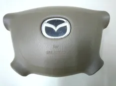 Подушка безопасности в рулевое колесо левая Mazda